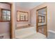 Bathroom with tiled tub and classic wood trim at 5000 Bainbridge Sw Ct, Lilburn, GA 30047