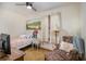 Bedroom with single bed, accent chair, and warm, inviting natural light at 5000 Bainbridge Sw Ct, Lilburn, GA 30047