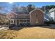 Traditional brick home with a covered front porch and well-maintained lawn, exuding curb appeal at 5000 Bainbridge Sw Ct, Lilburn, GA 30047