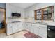 Bright kitchen featuring white cabinets, granite countertops, and modern appliances at 5000 Bainbridge Sw Ct, Lilburn, GA 30047