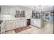 Bright kitchen featuring white cabinets, granite countertops, tile floor and modern appliances at 5000 Bainbridge Sw Ct, Lilburn, GA 30047