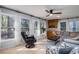 Comfortable living room with large windows providing natural light and view of the outdoors at 5000 Bainbridge Sw Ct, Lilburn, GA 30047