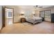 Open main bedroom with soft carpet, ceiling fan, and multiple windows at 5000 Bainbridge Sw Ct, Lilburn, GA 30047