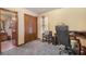 Home office with a desk, chair, and a view into an adjacent bathroom at 5000 Bainbridge Sw Ct, Lilburn, GA 30047