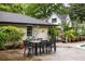 Backyard patio features a dark table with seating and colorful flowers at 705 W Ponce De Leon Ave, Decatur, GA 30030