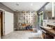 Spacious bathroom with decorative wallpaper, marble floors, and glass display case at 705 W Ponce De Leon Ave, Decatur, GA 30030