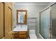 Elegant bathroom featuring a glass-enclosed shower and decorative framed mirror at 705 W Ponce De Leon Ave, Decatur, GA 30030