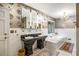 Elegant bathroom features a double vanity, chandelier, soaking tub and marble floors at 705 W Ponce De Leon Ave, Decatur, GA 30030
