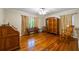 Comfortable bedroom with hardwood floors, natural light and antique furnishings at 705 W Ponce De Leon Ave, Decatur, GA 30030