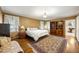 Primary bedroom showcasing a large rug, ensuite bathroom and natural light at 705 W Ponce De Leon Ave, Decatur, GA 30030