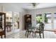 Bright dining area with tiled floors, glass table, and glass paneled doors leading to garage and living space at 705 W Ponce De Leon Ave, Decatur, GA 30030