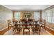 Formal dining room featuring elegant wallpaper, a large table, and sunlit windows at 705 W Ponce De Leon Ave, Decatur, GA 30030