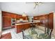 Spacious kitchen with cherry wood cabinets, stainless appliances, a large island, and glass dining table at 705 W Ponce De Leon Ave, Decatur, GA 30030