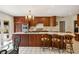 Open kitchen with a central island, counter seating, and updated appliances at 705 W Ponce De Leon Ave, Decatur, GA 30030