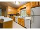 Cozy kitchen featuring wooden cabinetry, neutral countertops, and modern appliances at 705 W Ponce De Leon Ave, Decatur, GA 30030