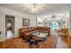 Comfortable living room with a leather sectional sofa, large rug, hardwood floors, and view of the pool at 705 W Ponce De Leon Ave, Decatur, GA 30030