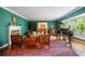 Stately living room featuring a fireplace, piano, and large windows with natural light at 705 W Ponce De Leon Ave, Decatur, GA 30030