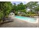 A beautiful backyard swimming pool with lounge chairs and manicured foliage at 705 W Ponce De Leon Ave, Decatur, GA 30030