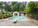 Backyard showcasing a private pool with a diving board and surrounding greenery at 705 W Ponce De Leon Ave, Decatur, GA 30030