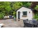 View of a brick pool house with a dark table and comfortable seating on the patio at 705 W Ponce De Leon Ave, Decatur, GA 30030