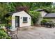 Brick pool house with a door and window surrounded by lush greenery at 705 W Ponce De Leon Ave, Decatur, GA 30030