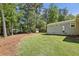 Spacious backyard features lush green grass and a shed, great for outdoor activities and storage at 1079 Pinedale Se Dr, Smyrna, GA 30080