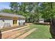 Large backyard featuring a wooden deck with a seating area, grass, and a storage shed at 1079 Pinedale Se Dr, Smyrna, GA 30080