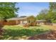 Lush backyard featuring a covered patio, playset, mature trees and fenced perimeter at 1079 Pinedale Se Dr, Smyrna, GA 30080