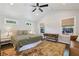 Bright bedroom featuring neutral walls, a vaulted ceiling, hardwood floors, an area rug, and multiple windows at 1079 Pinedale Se Dr, Smyrna, GA 30080