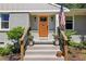 Charming front entrance with an orange door, decorative wreath, and American flag at 1079 Pinedale Se Dr, Smyrna, GA 30080