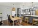 Open-concept kitchen featuring gray cabinetry, stainless appliances, an island, and an adjacent dining area with hardwood floors at 1079 Pinedale Se Dr, Smyrna, GA 30080