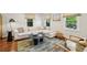 Bright living room with a large sectional sofa, stylish decor, and ample natural light at 1079 Pinedale Se Dr, Smyrna, GA 30080