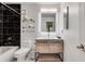 Stylish bathroom featuring black marble tile, a modern vanity and updated fixtures at 1426 N Crossing Ne Dr, Atlanta, GA 30329