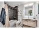 Modern bathroom features a tiled shower and tub combo and a sleek vanity with a lighted mirror at 1426 N Crossing Ne Dr, Atlanta, GA 30329