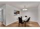 Elegant dining room with a glass-top table, modern chairs, and view to the kitchen at 1426 N Crossing Ne Dr, Atlanta, GA 30329