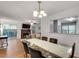 Open floorplan dining area features glass table, hardwood floors and seamlessly flows to living area at 1426 N Crossing Ne Dr, Atlanta, GA 30329