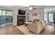 Cozy living room features a fireplace, comfortable seating, and access to a private patio at 1426 N Crossing Ne Dr, Atlanta, GA 30329