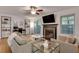 Well-lit living area features neutral decor, hardwood floors, a ceiling fan, and fireplace at 1426 N Crossing Ne Dr, Atlanta, GA 30329