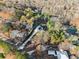 Aerial view of a modern home on a long lot, surrounded by lush greenery and a beautifully maintained yard at 1540 Brooks S Rd, Lawrenceville, GA 30045