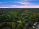 Aerial view reveals the home in a tranquil neighborhood, surrounded by lush greenery and mature trees at 1540 Brooks S Rd, Lawrenceville, GA 30045
