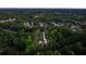 High angle aerial view shows the home surrounded by a lush green canopy of trees and other neighborhood homes at 1540 Brooks S Rd, Lawrenceville, GA 30045