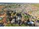 Aerial view of a modern home on a sprawling lot, showcasing its secluded setting among lush trees at 1540 Brooks S Rd, Lawrenceville, GA 30045