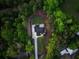 Bird's eye view of new construction showing architectural design with fresh landscaping, nestled in a tree-filled area at 1540 Brooks S Rd, Lawrenceville, GA 30045