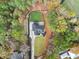 Top-down aerial of modern home with dark roof, driveway, grass and mulch, nestled in mature trees at 1540 Brooks S Rd, Lawrenceville, GA 30045