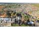 An aerial view of a new construction, modern home on a sprawling lot surrounded by lush trees at 1540 Brooks S Rd, Lawrenceville, GA 30045