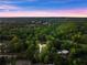 Wide aerial perspective displays the house nestled in a well-treed suburban area near a quiet roadway at 1540 Brooks S Rd, Lawrenceville, GA 30045
