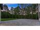 Large backyard area with a stone-paved patio and a view of the surrounding trees at 1540 Brooks S Rd, Lawrenceville, GA 30045