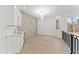 Elegant bar area with white cabinets, marble backsplash, gold hardware, and a beverage fridge for entertaining at 1540 Brooks S Rd, Lawrenceville, GA 30045