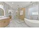 Gorgeous bathroom featuring a soaking tub, glass shower, and vanities, and marble throughout at 1540 Brooks S Rd, Lawrenceville, GA 30045