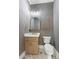 Modern powder room boasts stylish vanity, elegant gold fixtures, and unique textured gray walls at 1540 Brooks S Rd, Lawrenceville, GA 30045
